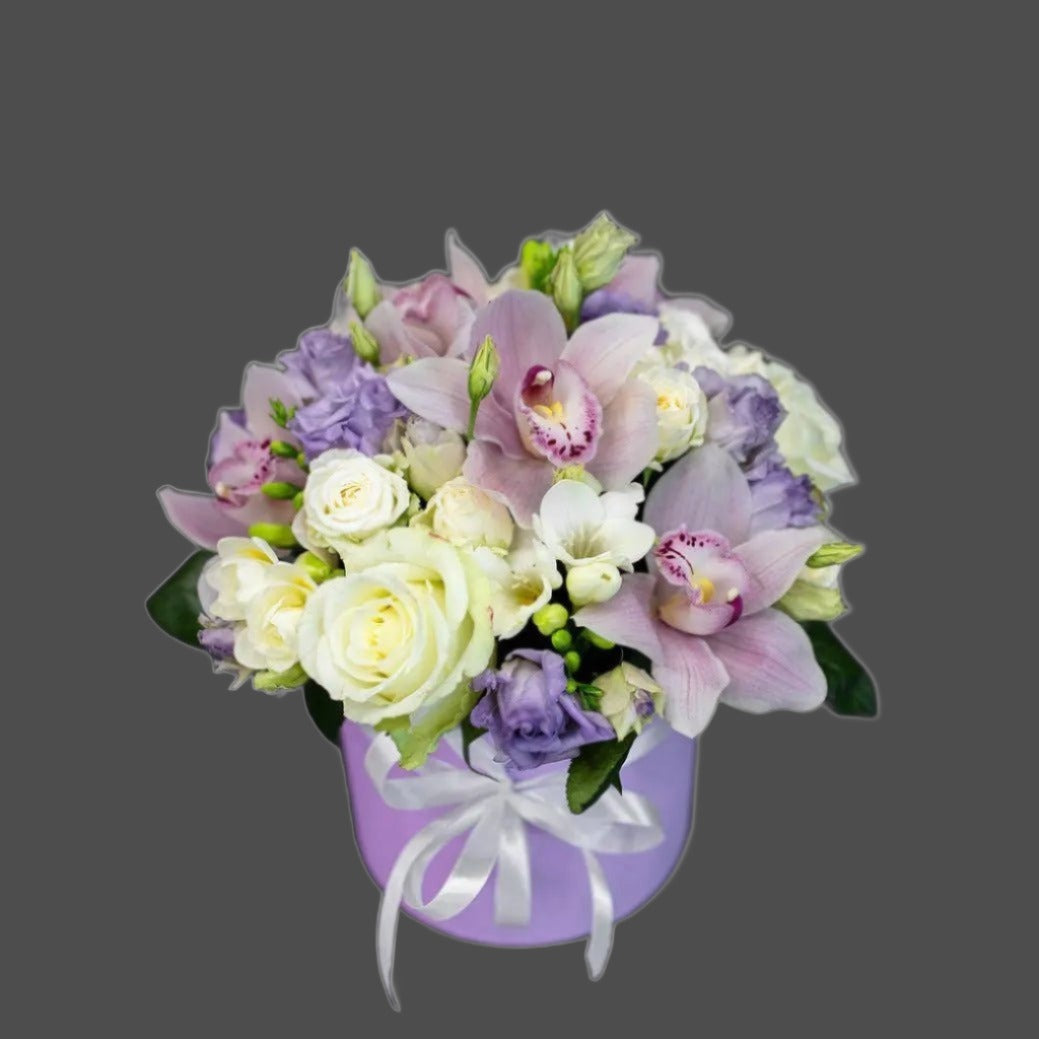A stunning bouquet of roses, lisianthus and cymbidium in a violet box