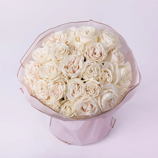 A bouquet of two dozen charming ivory roses