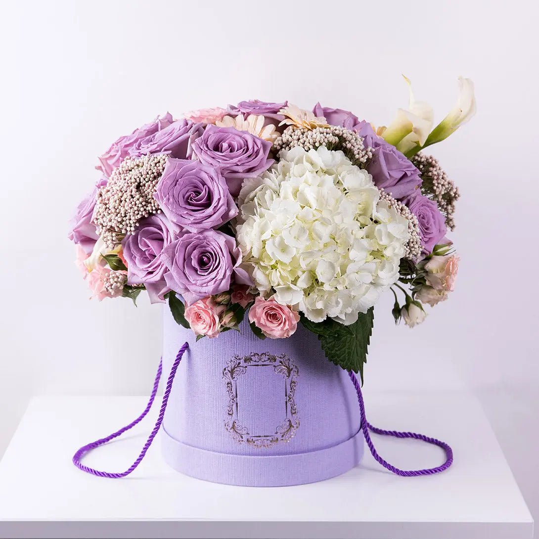 Arrangement of lavender roses in a purple box