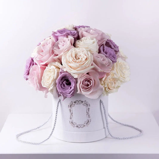 Gorgeous combination of premium roses in ivory, pink and lavender in a white box