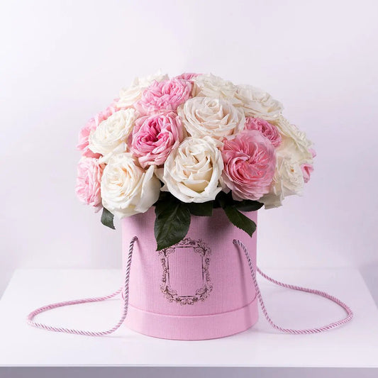 Charming mix of pink garden roses and white premium roses in a pink box